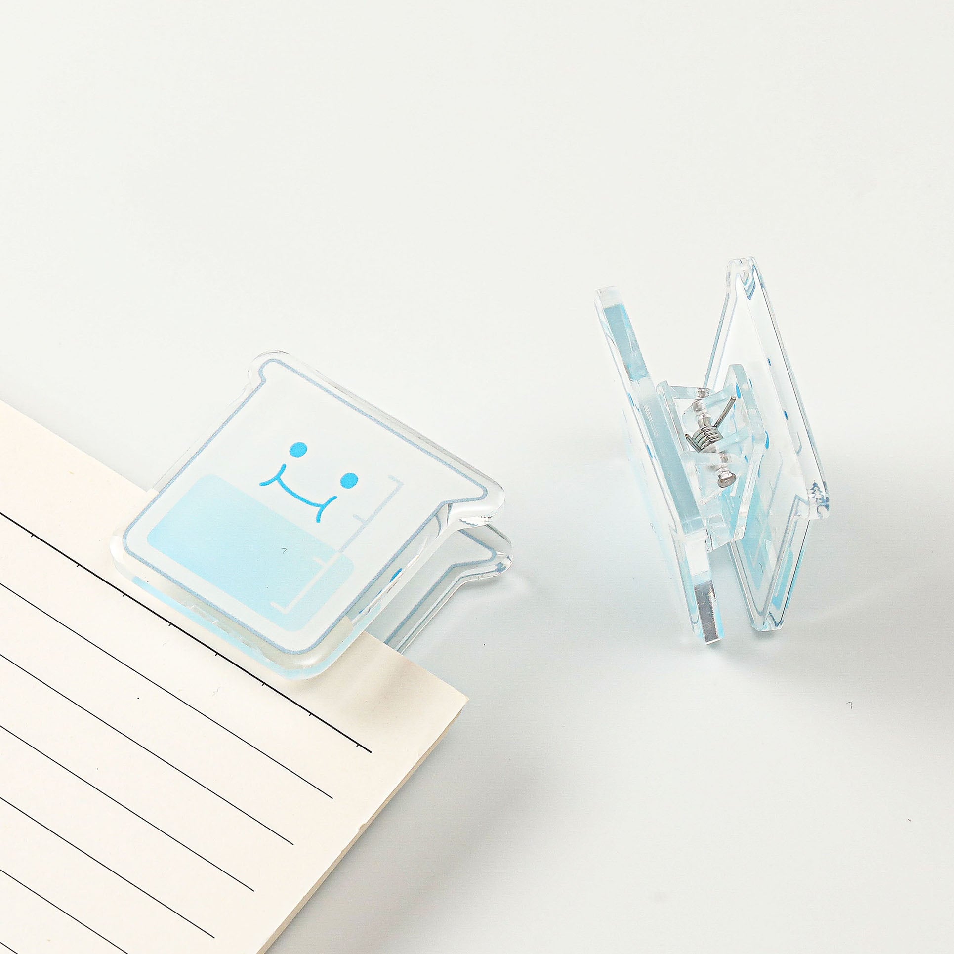 Cartoon chemistry beaker acrylic document clip featuring a clear layered construction, a fun desk accessory for science enthusiasts and students.