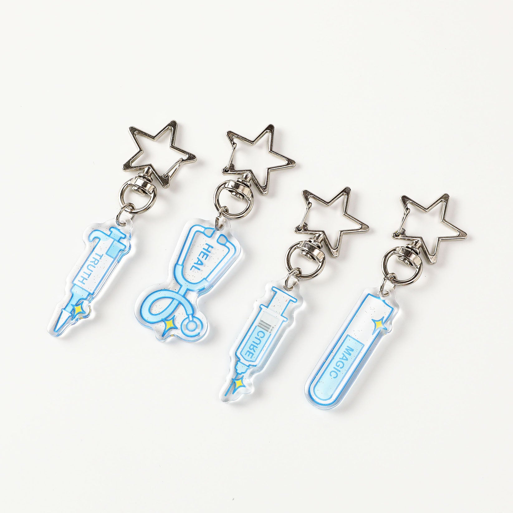 Blue glitter acrylic science keychain assortment with medical instrument charms, transparent finish, and polished star key rings for everyday accessories.