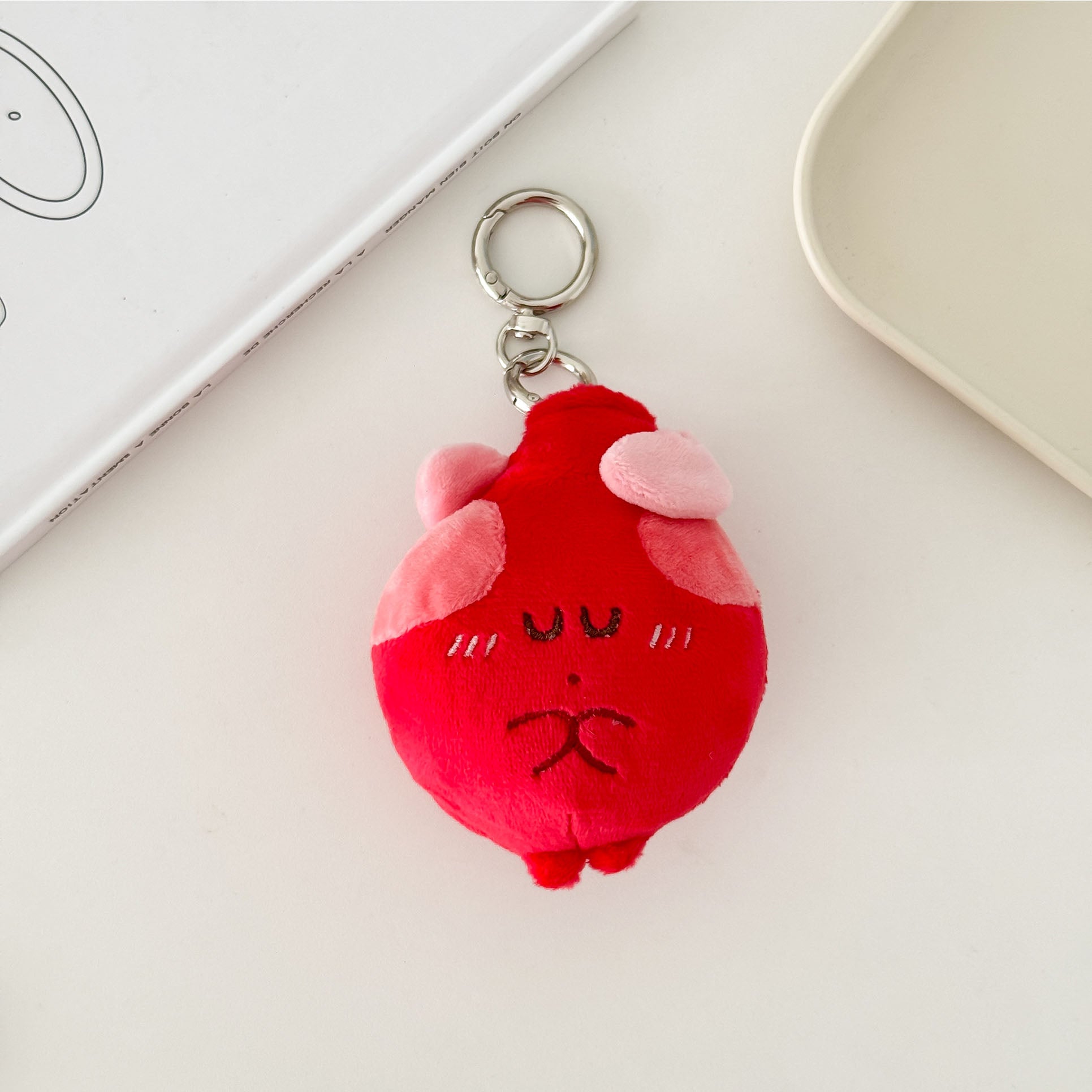 Soft heart anatomy plush keychain featuring a cute embroidered face and pink heart details.