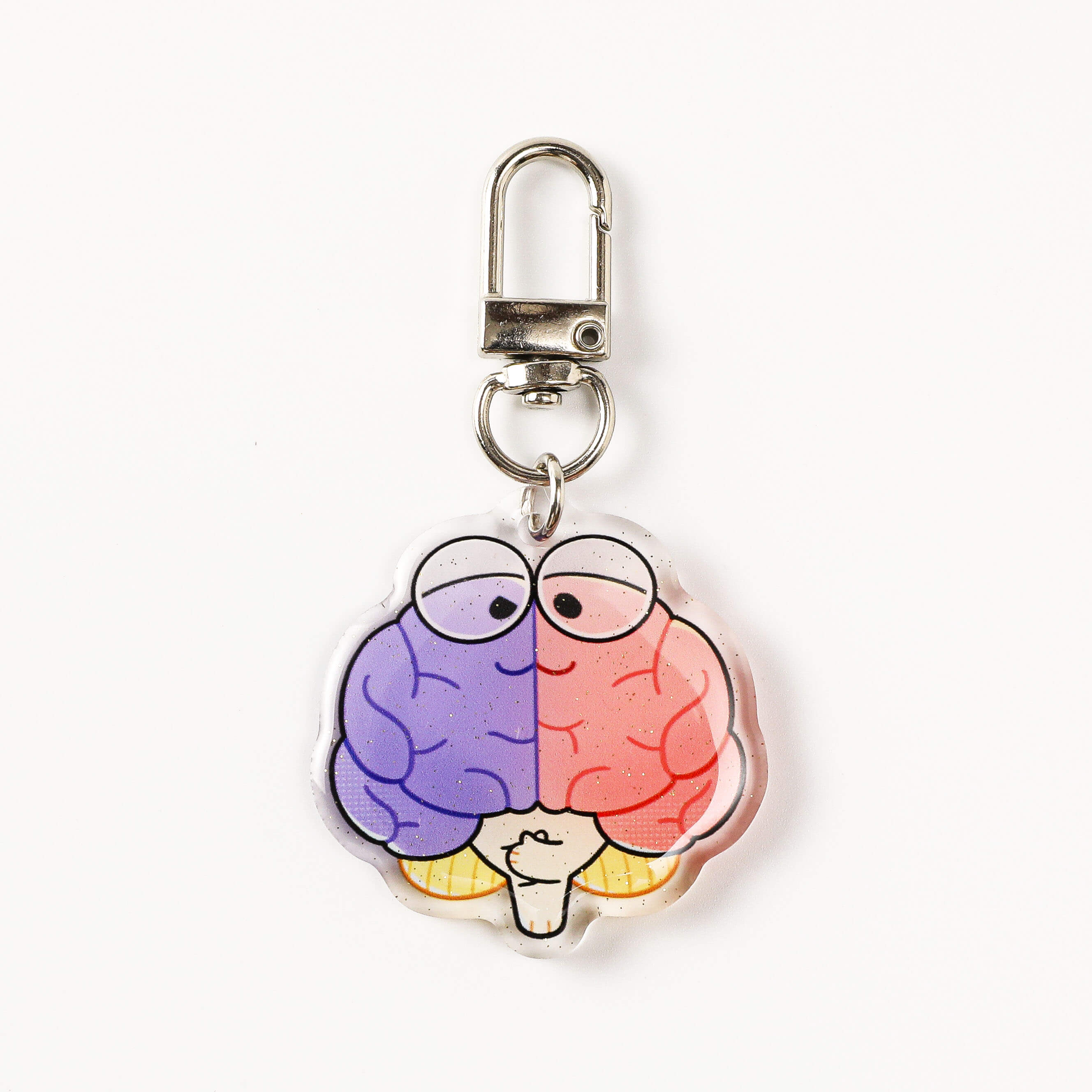 Left and right brain acrylic charm with contrasting pastel colors and polished edges, a creative neuroscience-inspired accessory for keys and bags.