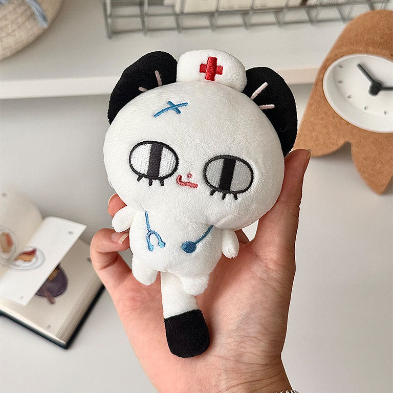 Nurse cat stuffed animal with black ears, white plush fabric, and healthcare-inspired design.