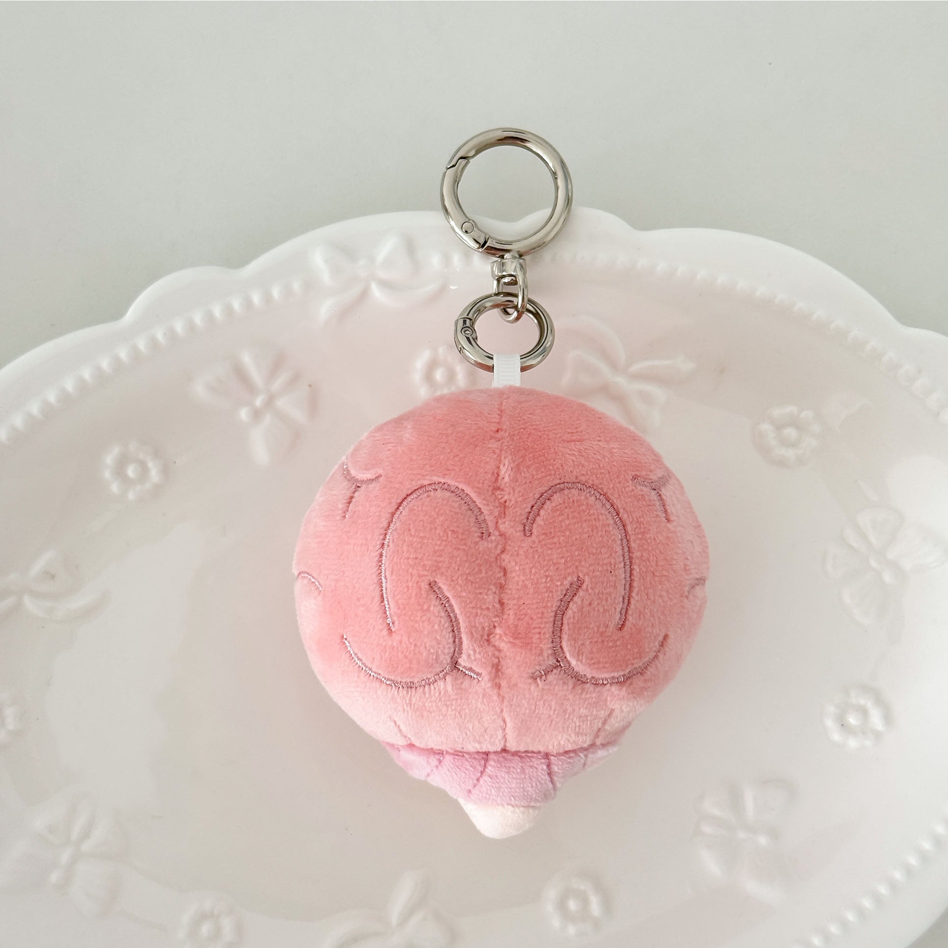 Adorable anatomy brain plush keychain with soft fabric, cute face, and silver keychain hardware.