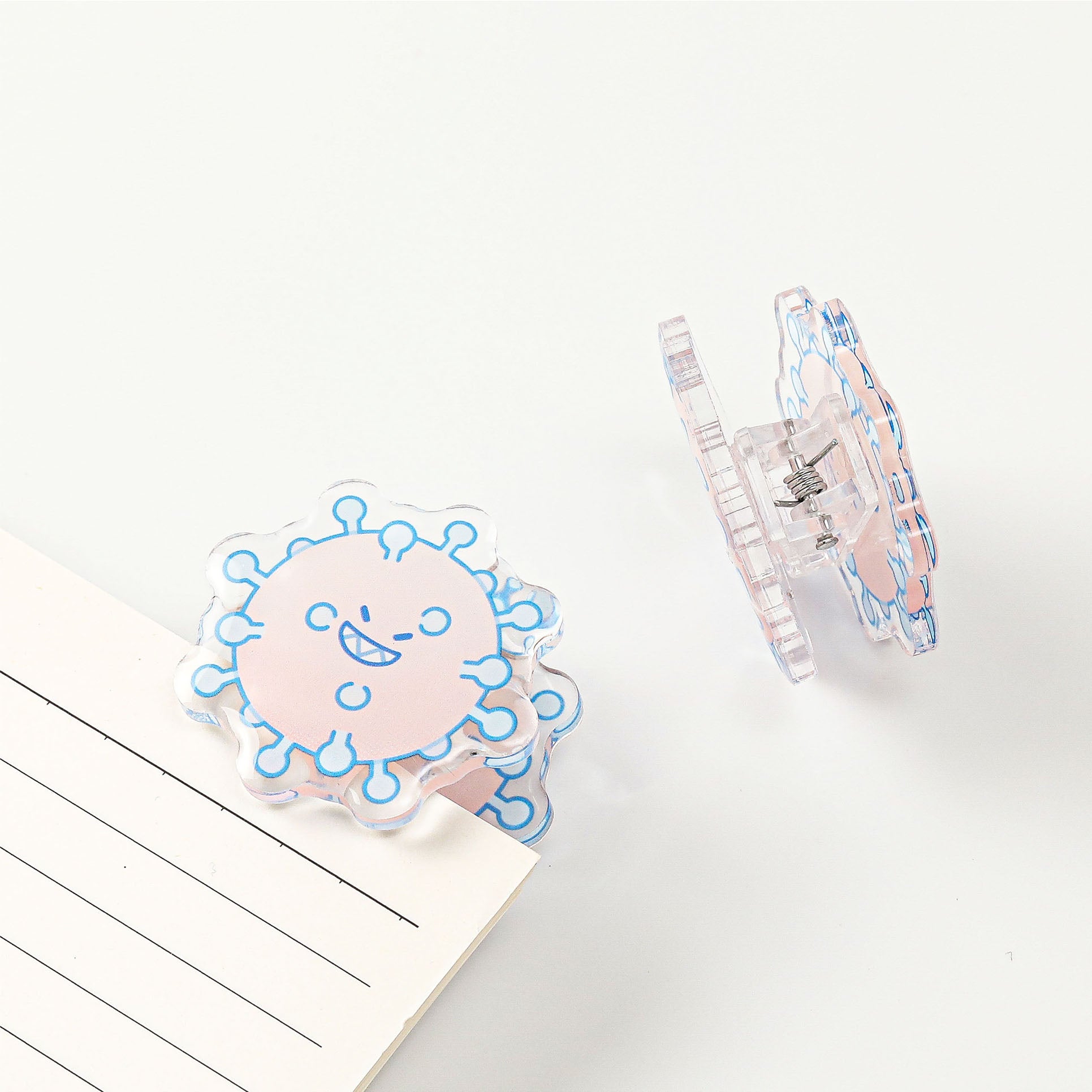 Pink germ acrylic stationery clip with a cheerful science-inspired character, a fun desk organizer for students, teachers, and laboratory enthusiasts.