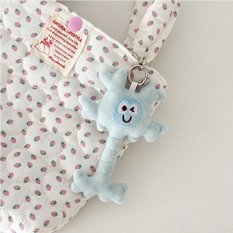 Cute plush neuron keychain inspired by neuroscience with soft blue finish and metal key ring.