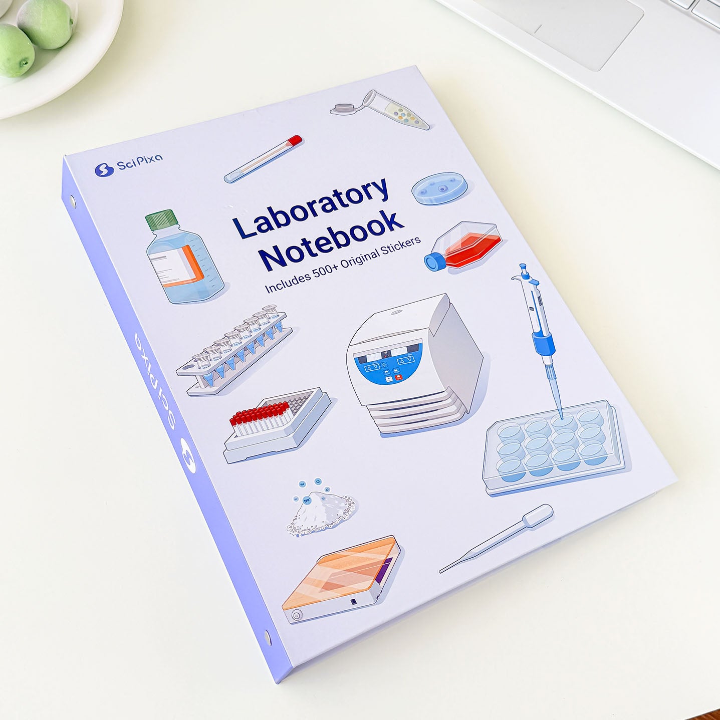 Laboratory notebook with detailed illustrations of lab instruments, scientific equipment, and research tools for students and scientists.
