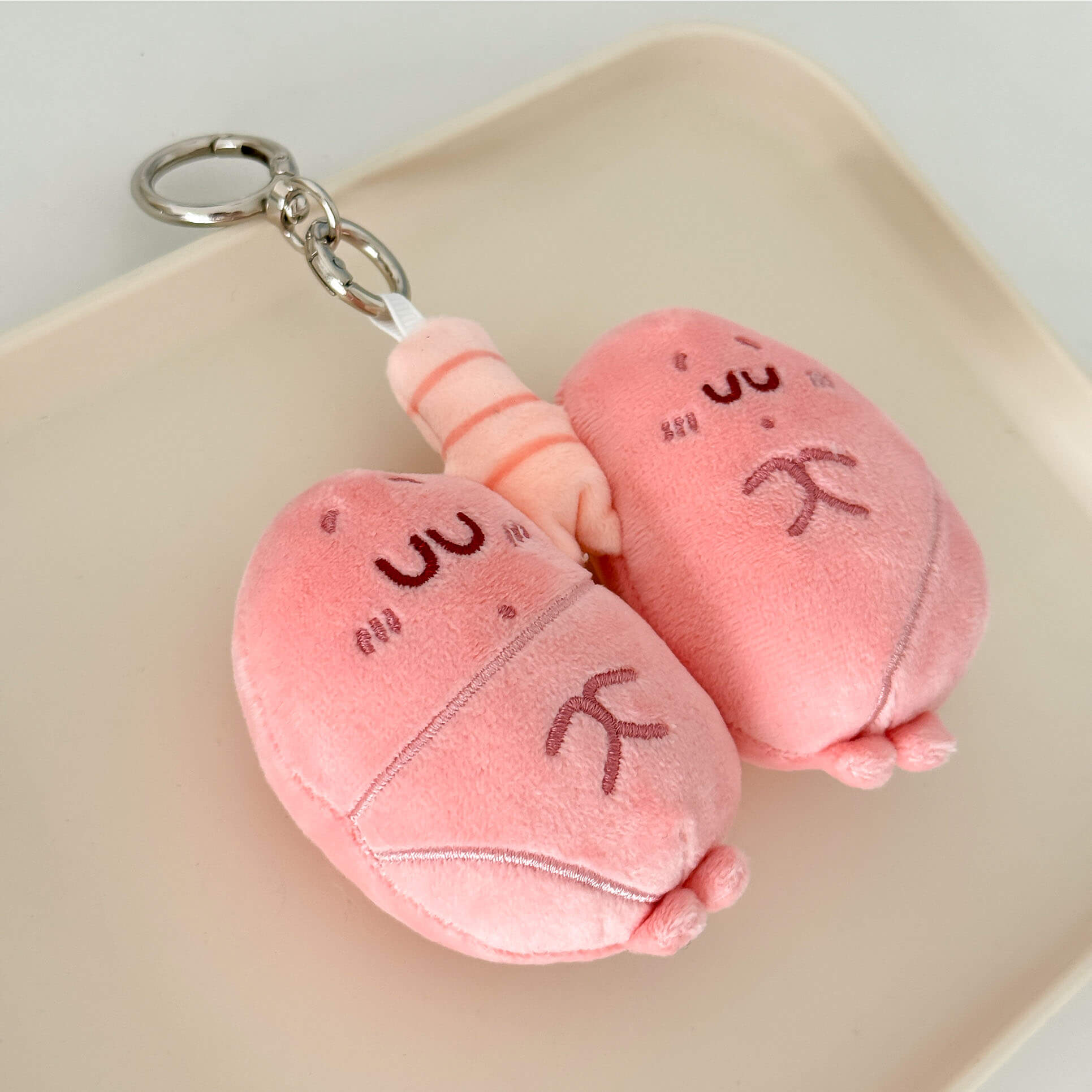 Lung organ stuffed keychain with fluffy plush texture and secure metal ring attachment.