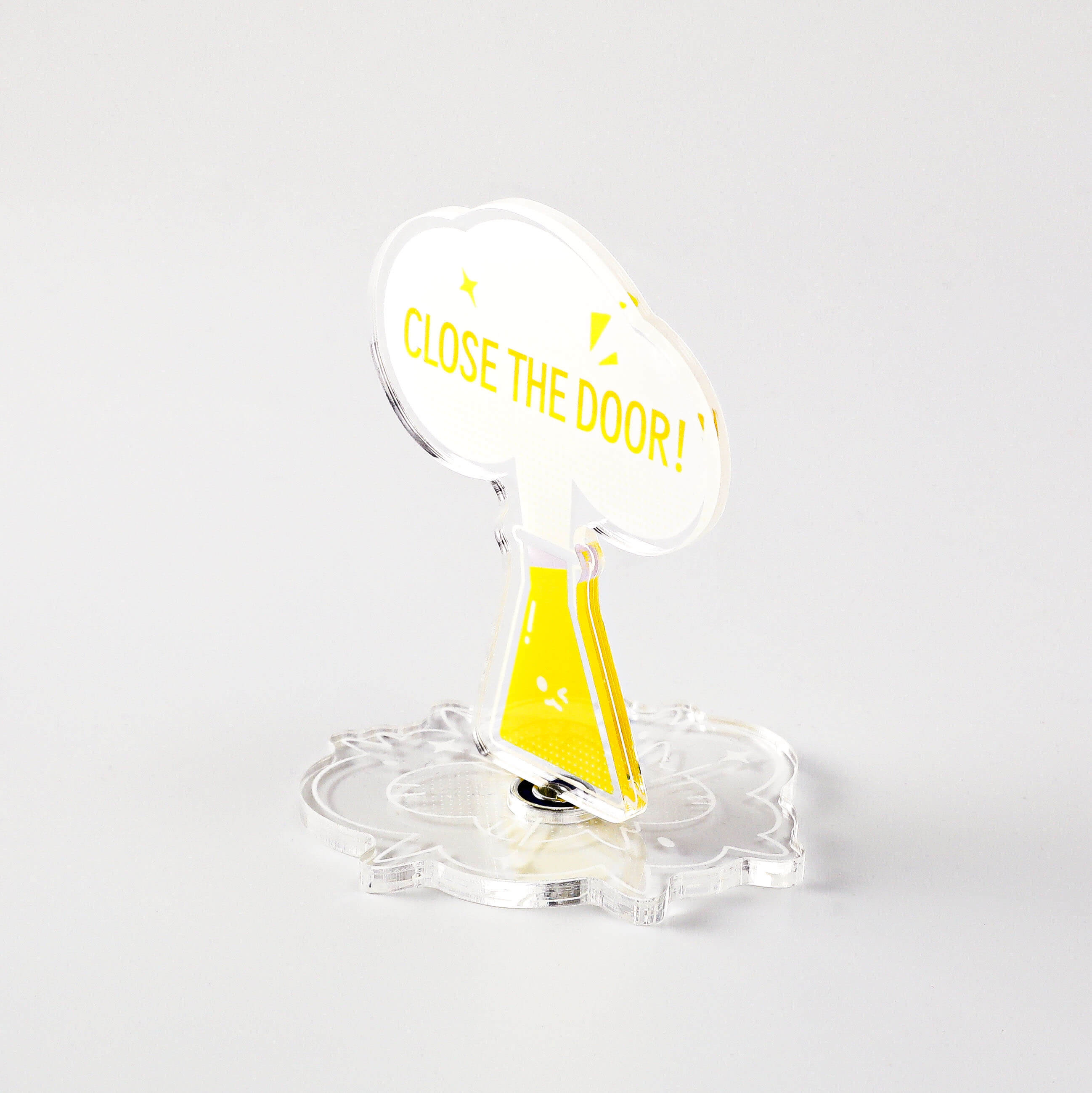 Science-themed acrylic desk stand featuring a yellow flask character and "CLOSE THE DOOR!" message.